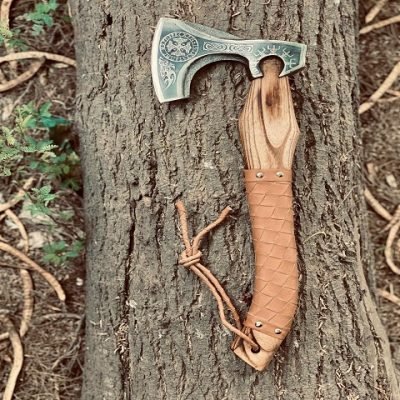 Intricate design details on wooden handle of handmade camping axe